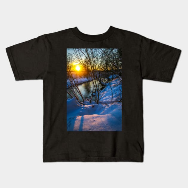 Snow falling on a river with snowy banks Kids T-Shirt by Olga Berlet